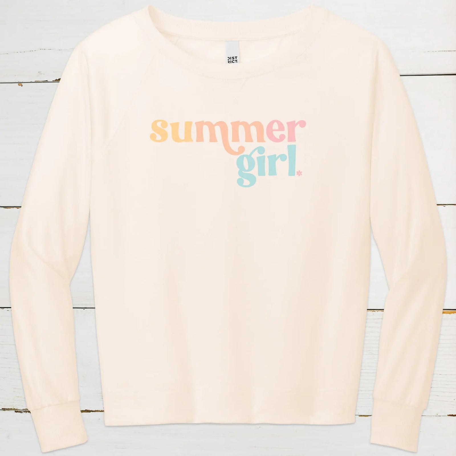 District Featherweight crewneck in cream color with summer girl printed in beachy colors