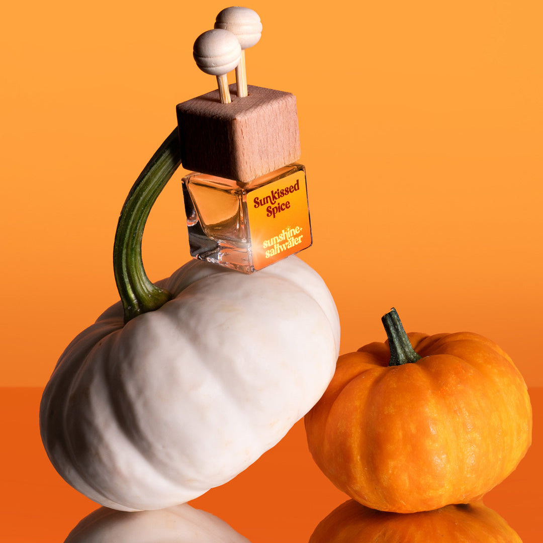 Car Diffuser labeled &#39;Sun Kissed Spice&#39; on a white pumpkin with an orange background
