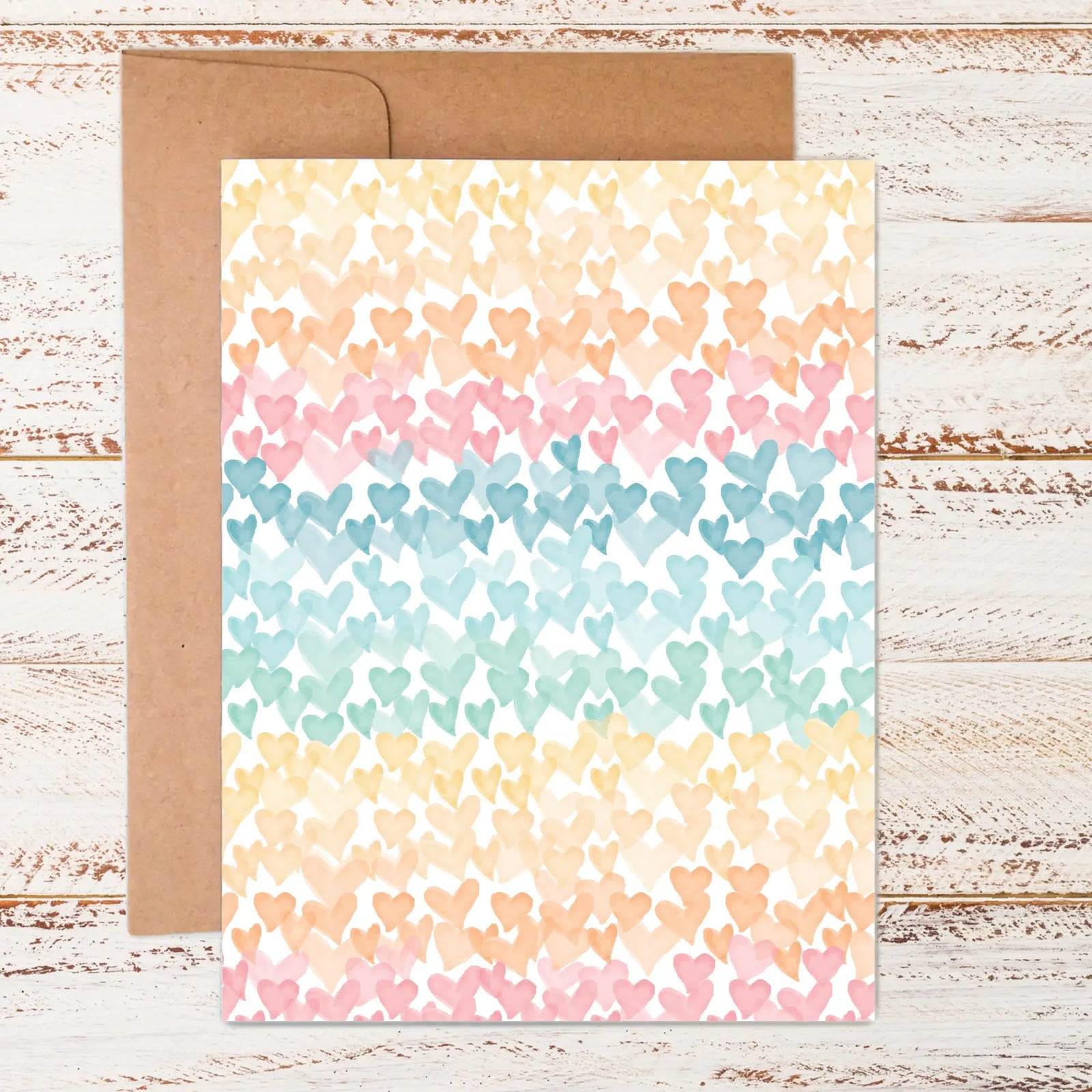 flat lay of hearts on the horizon greeting card with stickers and kraft paper envelope