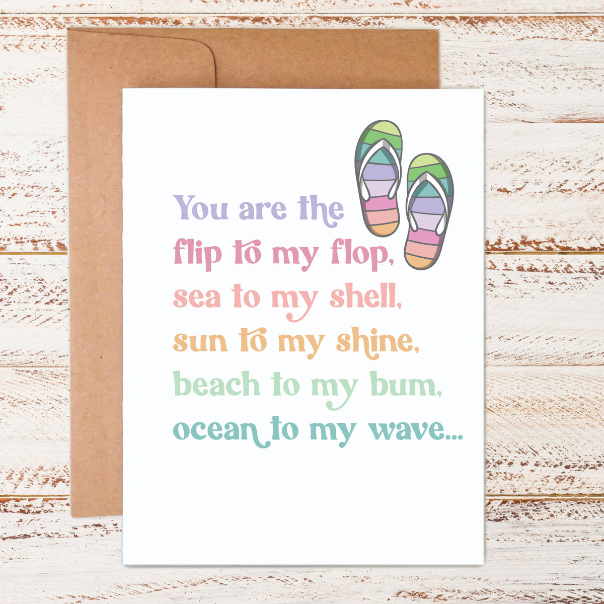 Flip flop greeting card with colorful fonts on white cover stock in front of kraft paper envelope