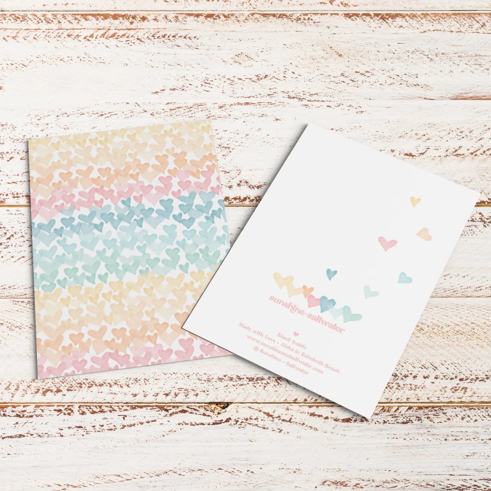 flat lay of hearts on the horizon greeting card with stickers and kraft paper envelope