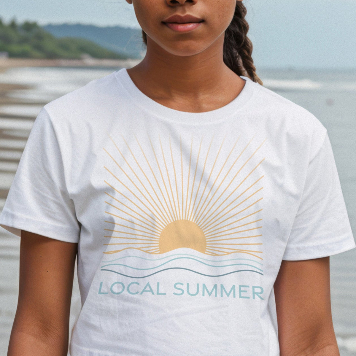 Person wearing a &#39;Local Summer&#39; t-shirt on a beach