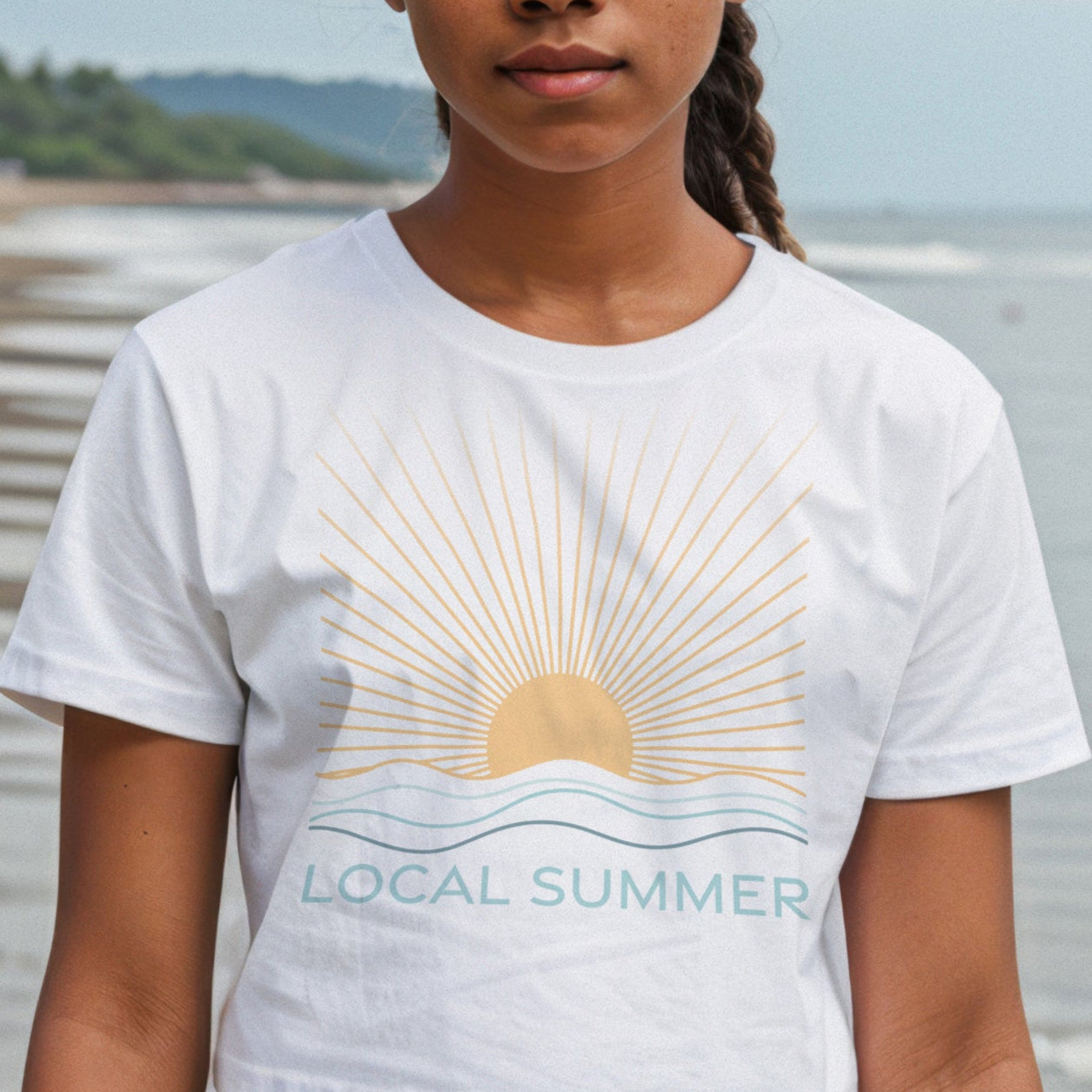 Person wearing a 'Local Summer' t-shirt on a beach