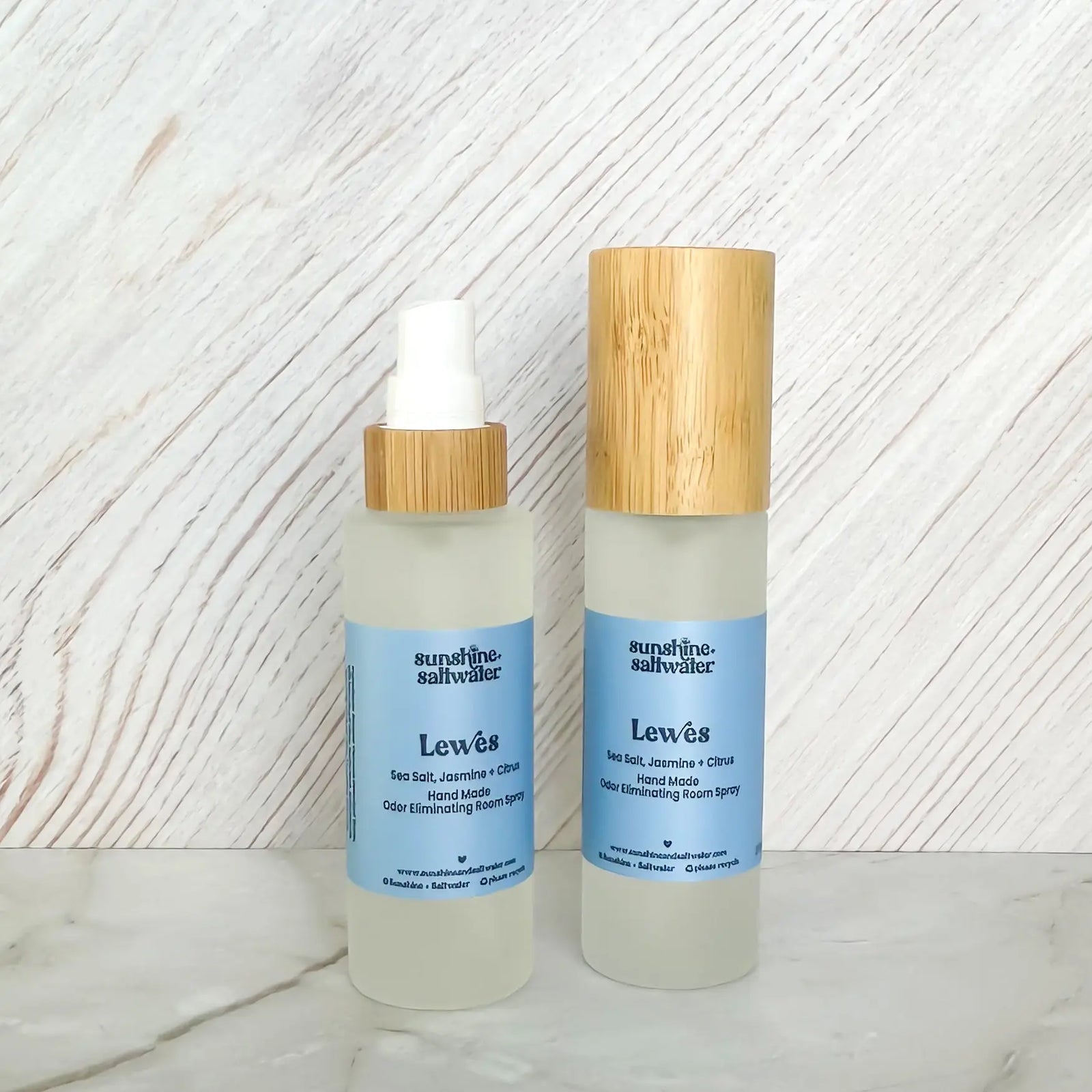 jasmine, sea salt, and Citrus room spray display with blue label and wooden topper