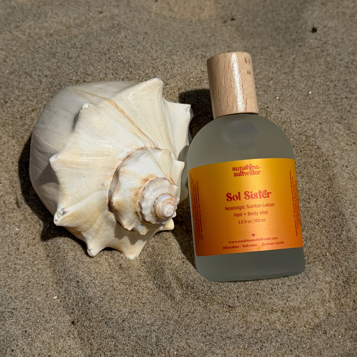 Sol Sister Body Mist in sand with shell