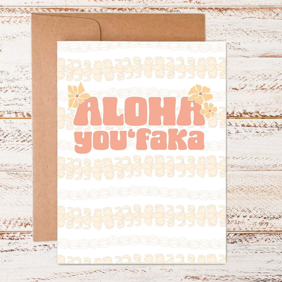 flat lay of aloha you&#39;faka greeting card with kraft paper envelope