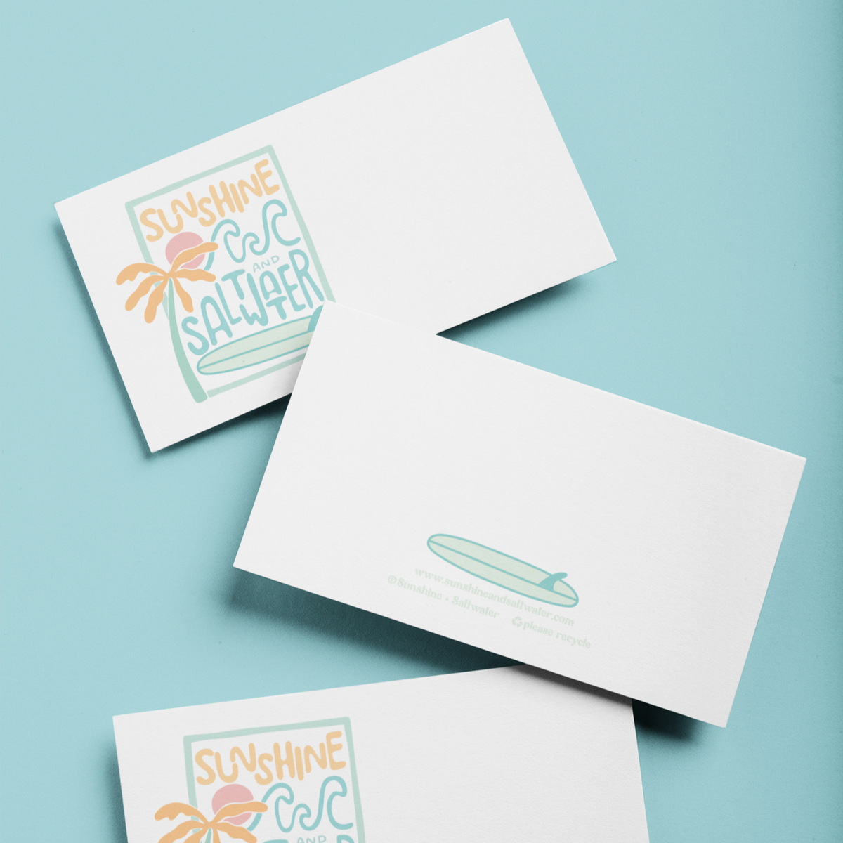 tiny greeting card with sunshine and saltwater and surfboard graphic on white card