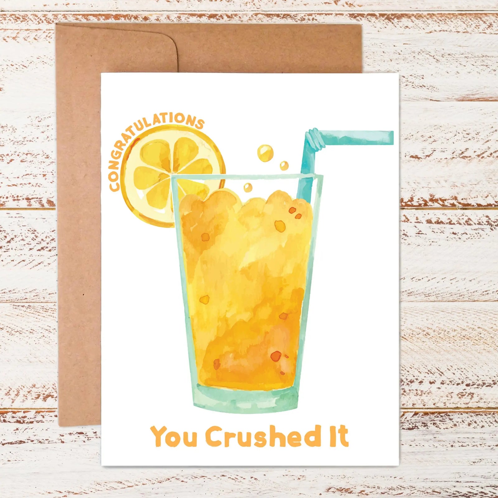 flat lay of congratulations-you crushed it greeting card featuring graphic of an orange crush drink